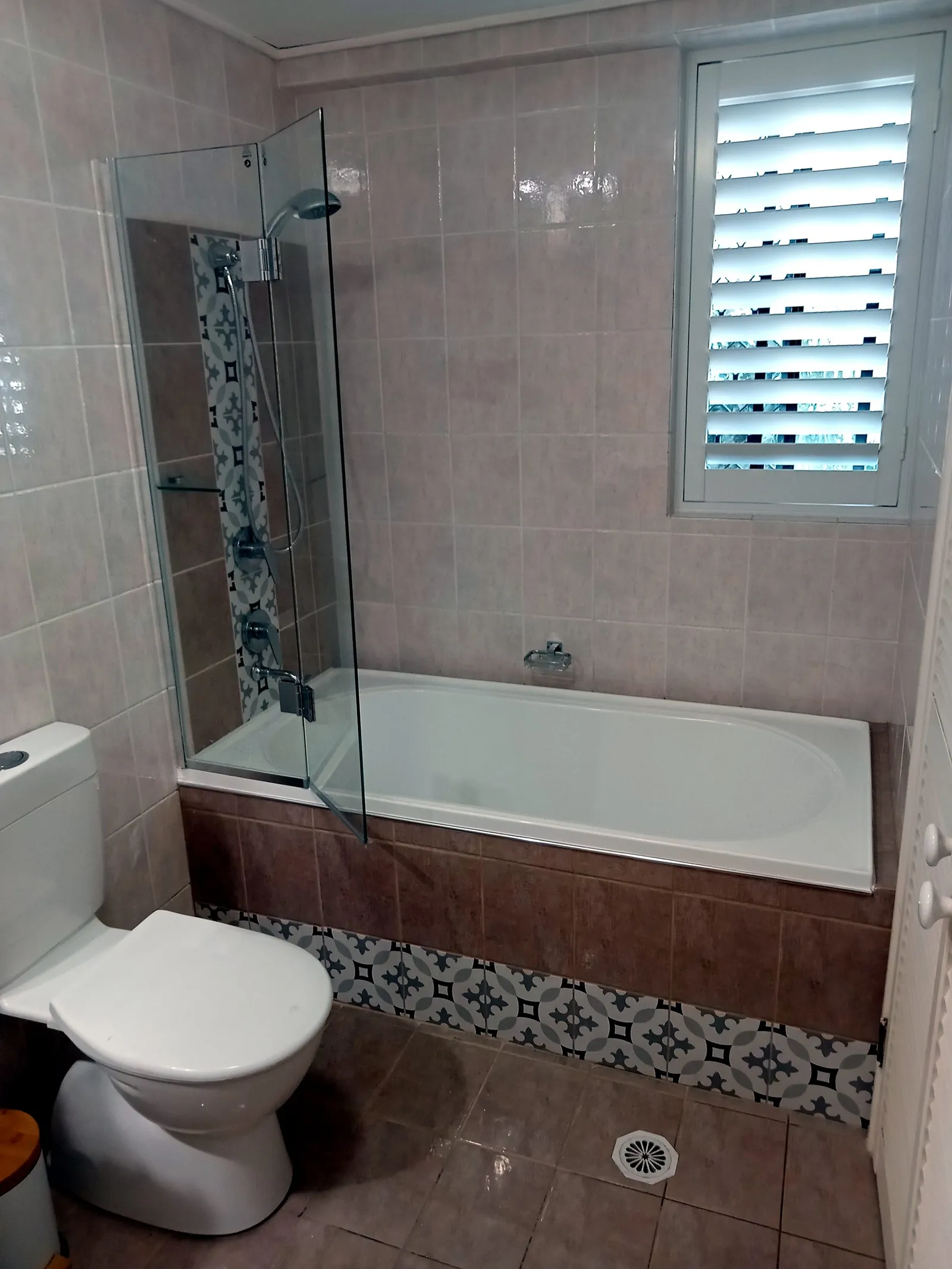 Modern renovated bathroom on the Gold Coast with quality tiling and glass shower screen