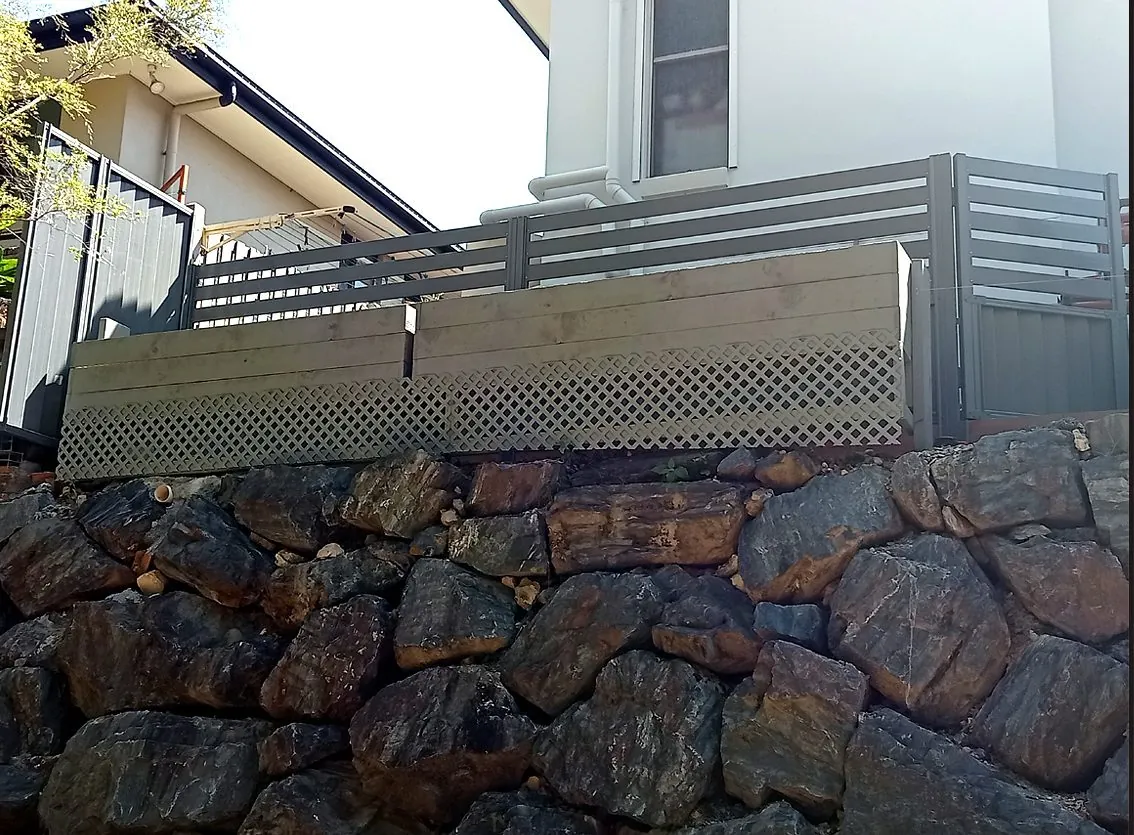 Guard rail installed above rock retaining wall Gold Coast - safety installation