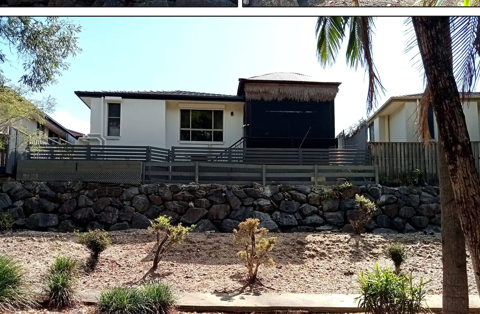 Rock retaining wall with guard rail fence and landscaping Gold Coast